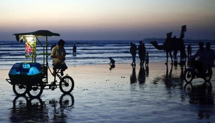 An undated image of people at Karachis Sea View. — AFP/File