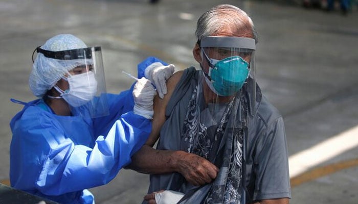 A senior citizen receives a dose of a COVID-19 vaccine in Lima, Peru March 23, 2021. — Reuters