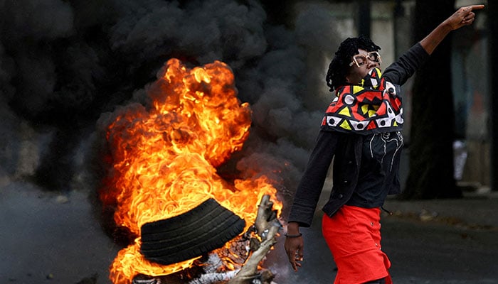 A protester reacts near a burning barricade during a national shutdown against the election outcome, at Luis Cabral township in Maputo, Mozambique, November 7, 2024. — Reuters