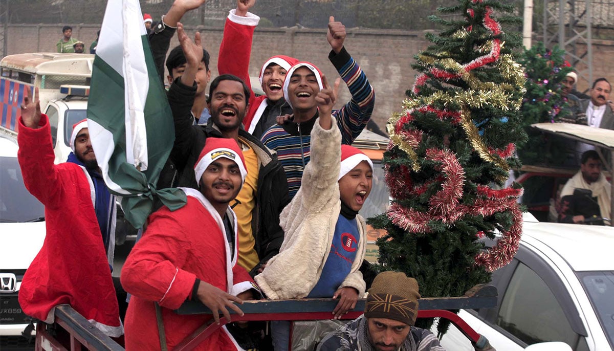 Members of Christian community dressed as Santa Claus are moving in a vehicle down the road in Peshawar December 21, 2024. — PPI