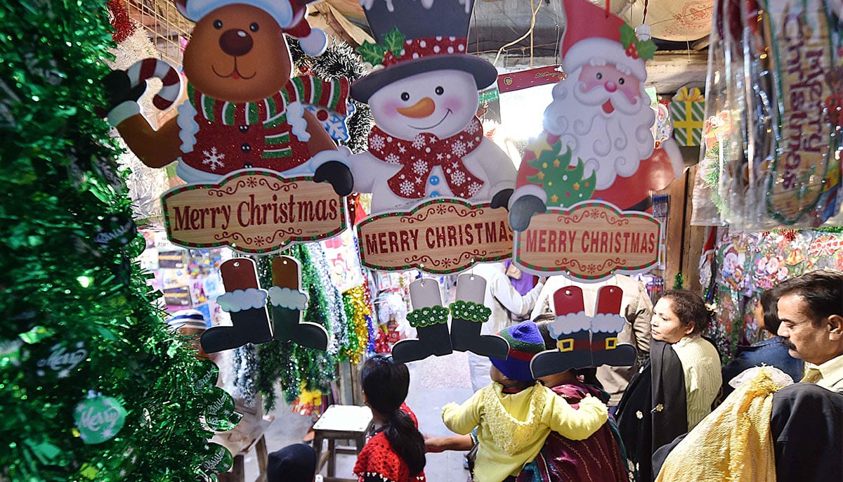 People check out Christmas decorations and seasonal merchandise on sale for the upcoming Christmas celebrations at a shop in Karachi on December 22, 2024. — INP