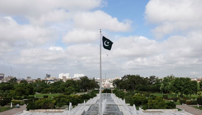 National flag flutters during a ceremony to celebrate the countrys 75th Independence Day, at the Mazar-e-Quaid in Karachi on August 14, 2022. — Reuters