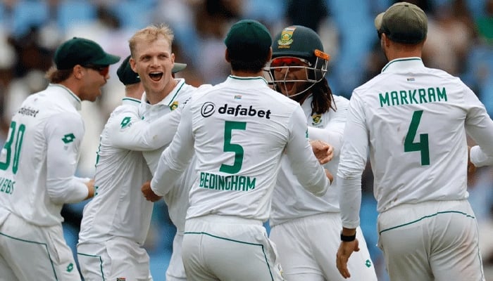 South African Corbin Bosch celebrates with his team after dismissing Pakistan skipper Shan Masood on day one of the first Test against Pakistan at Centurion on December 26, 2024. - AFP