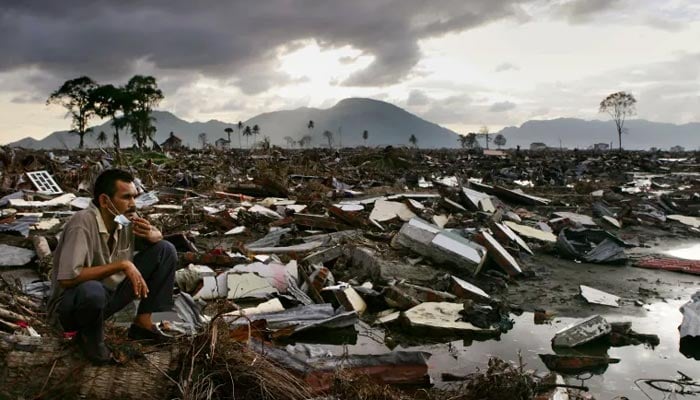 An Acehnese man among the ruins in Banda Aceh, on January 13, 2005, weeks after the 2004 Indian Ocean tsunami. — AFP/File