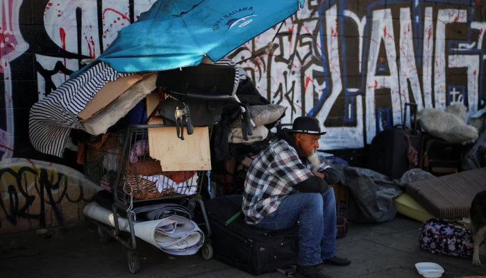 A man sits on a street in Skid Row, Los Angeles, California, US, on December 9, 2024. —Reuters