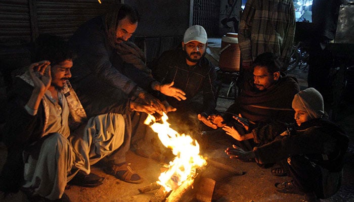 A representational image of people warm their hands on bone-fire to save themselves from cold waves during the winter season, in Hyderabad on Sunday, December 22, 2024. — APP