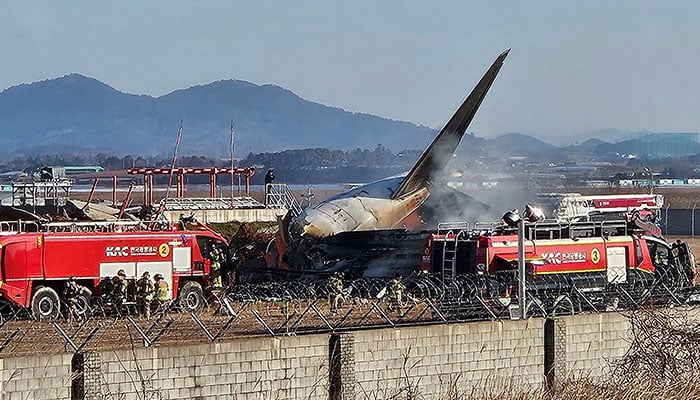 Firefighters carry out extinguishing operations on an aircraft which drove off runway at Muan International Airport in Muan, South Jeolla Province, South Korea on December 29, 2024. — Reuters