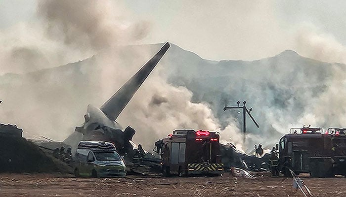 Firefighters carry out extinguishing operations on an aircraft which drove off runway at Muan International Airport in Muan, South Jeolla Province, South Korea on December 29, 2024. — Reuters