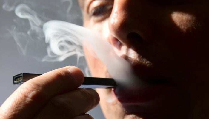 A man exhales smoke from an electronic cigarette in Washington, DC. — AFP/File