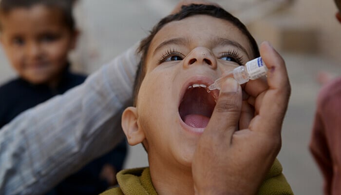 A child is being administered oral vaccine against polio. — AFP/File