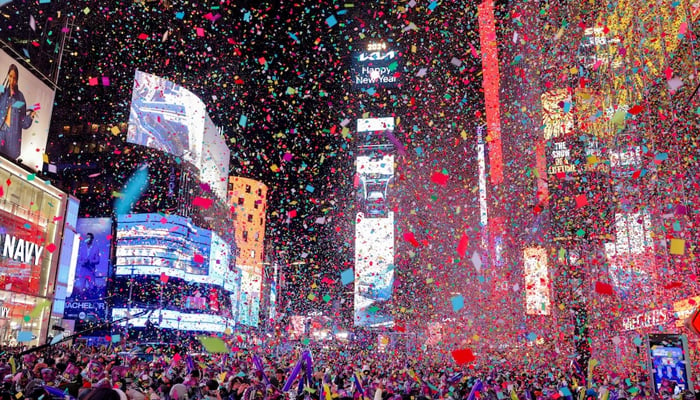 People watch confetti flying around after the clock strikes midnight during New Year celebrations at Times Square, in New York City, New York, US, January 1, 2024. — Reuters