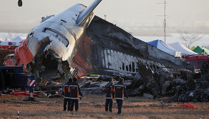 Firefighters take a look at the wreckage of the aircraft that crashed after it went off the runway, at Muan International Airport, in Muan, South Korea, December 31, 2024. — Reuters