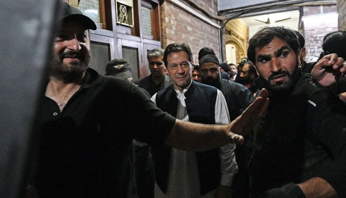 PTI founder Imran Khan leaves after appearing at the Lahore High Court on March 17, 2023. — AFP