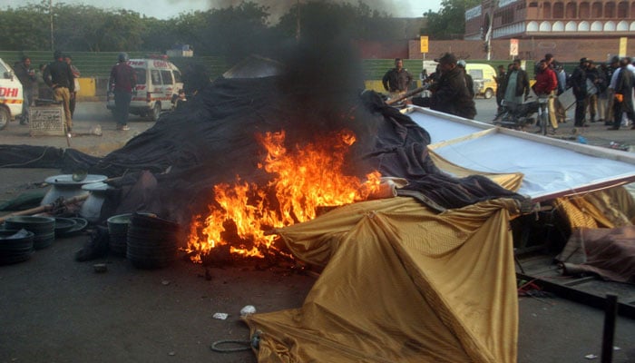 A view of burning camp during a clash between the activists of MWM and police in Karachi on December 11, 2024. — Online