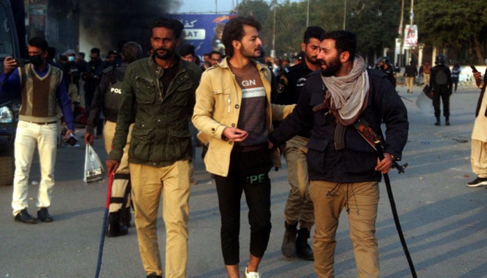 Police arrest an activist of MWM during sit-in at Karachi’s Numaish Chowrangi on December 31, 2024. — Online