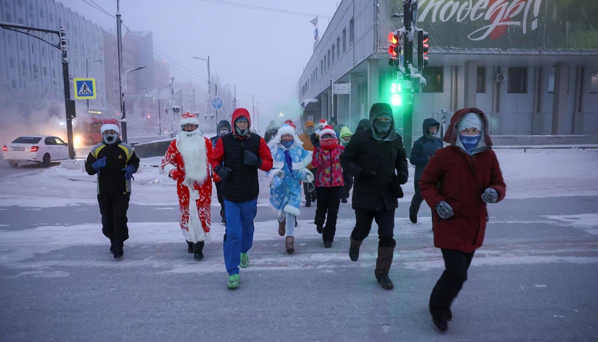 Participants of the New Years Eve race run along a street after the temperature went below -47 degrees Celsius (minus 52.6 degrees Fahrenheit) in Yakutsk, the capital of the Sakha Republic located in the northeastern part of Siberia, Russia, December 31. — Reuters