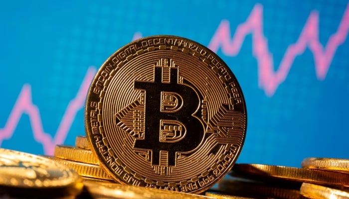 A representation of virtual currency Bitcoin is seen in front of a stock graph in this illustration taken November 19, 2020. — Reuters