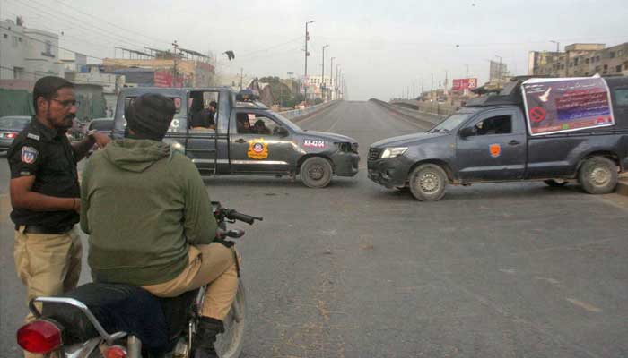 Police personals blocked Shahrae Pakistan with police vans due to MWM sit-in protest in Karachi. — Online