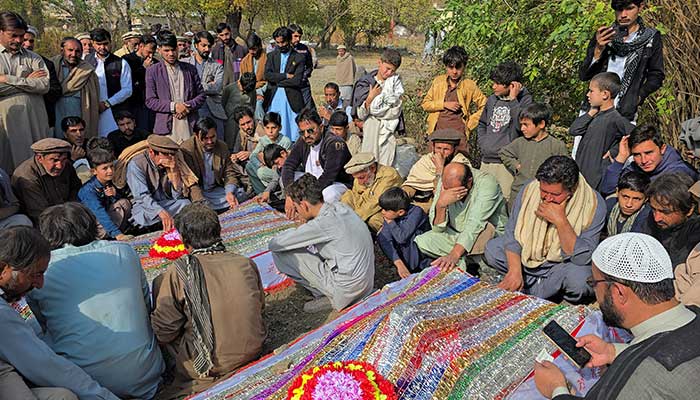 People mourn over the graves of relatives who were killed after gunmen opened fire on passenger vehicles in the Kurram tribal district of Khyber Pakhtunkhwa province, in Shalozan, November 22, 2024. — Reuters