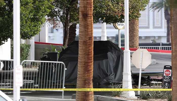 The remains of a covered Tesla Cybertruck, that burned at the entrance of Trump Tower, stand behind yellow tape, in Las Vegas, Nevada, U.S. January 1, 2025. — Reuters