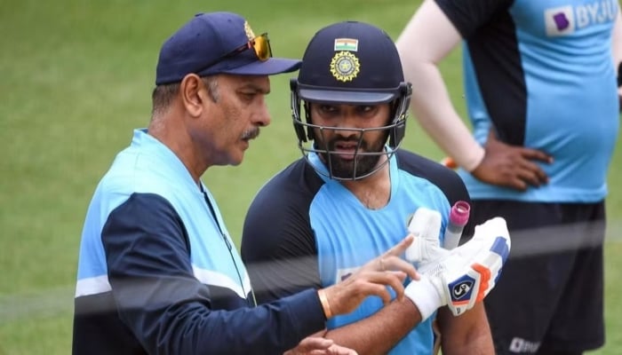 Indias Rohit Sharma chats with then team coach Ravi Shastri during a training session at the MCG in Melbourne on January 2, 2021. — AFP