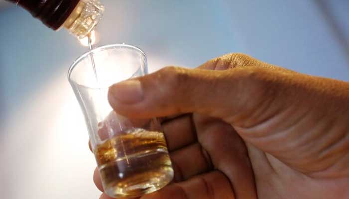 A representational image shows an employee pouring alcohol in a glass in Phnom Penh, Cambodia, October 18, 2018. — Reuters