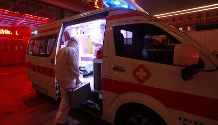 A medical worker in protective suit gets into an ambulance at a hospital in Xuanhua district of Zhangjiakou, Hebei province, China February 13, 2020. — Reuters