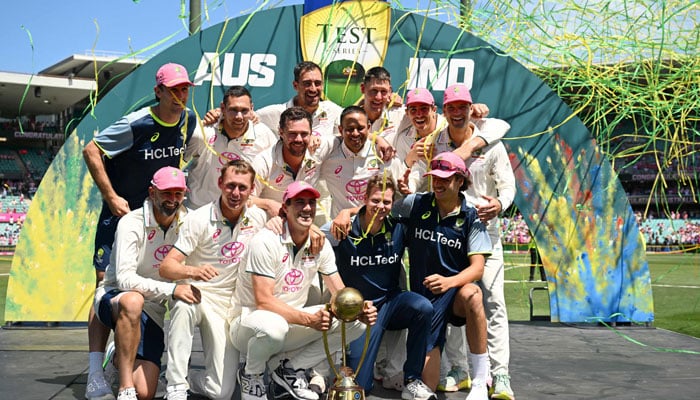 Australia players pose with the Border-Gavaskar Trophy after winning the fifth Test match and series against India at the Sydney Cricket Ground on January 5, 2025.  — Reuters