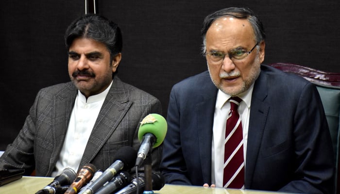 Planning Minister Ahsan Iqbal (right) talks to reporters along side PPP leader and Sindh Minister Nasir Hussain Shah in Karachi, on January 6, 2025. — PID