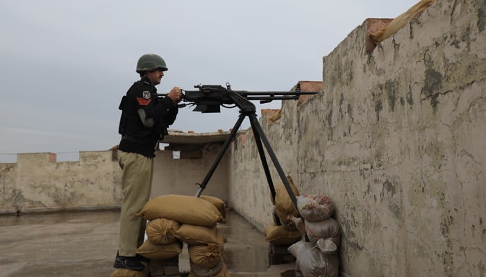 A police officer with a 12.7mm infantry machine gun takes position at Sarband Police Station’s rooftop, in the outskirts of Peshawar, February 9, 2023. — Reuters