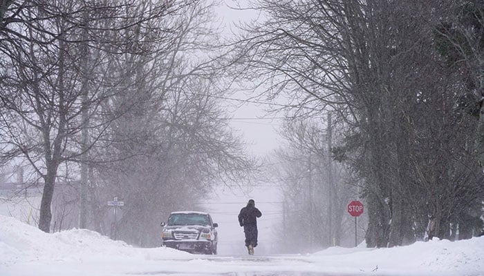 A person walks down a street during a winter storm in Souris, Prince Edward Island, Canada, January 6, 2025. — Reuters