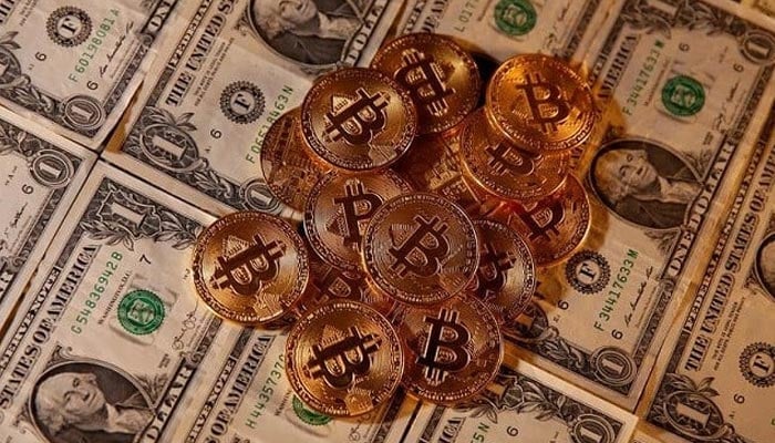 Representations of virtual currency Bitcoin are placed on US dollar banknotes in this illustration. — Reuters/File