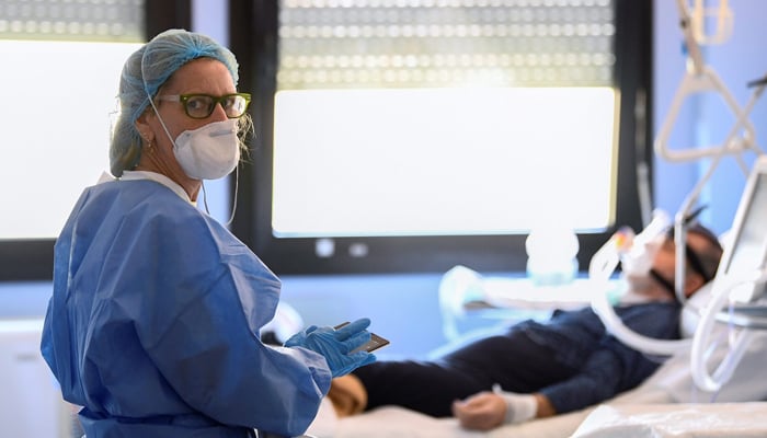 A representational image of an Italian medical worker wearing a protective mask and suit as she treats a patient suffering from coronavirus in an intensive care unit at the Oglio Po hospital in Cremona, Italy March 19, 2020. — Reuters