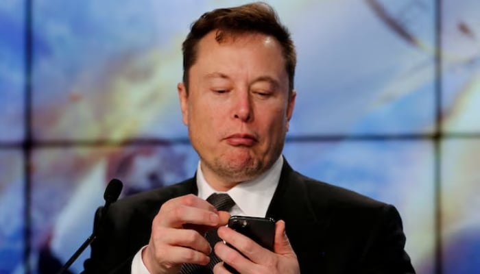 Elon Musk looks at his mobile phone in Cape Canaveral, Florida, US, on January 19, 2020. — Reuters