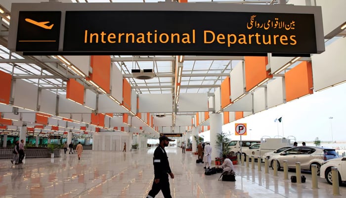 A worker walks at the departure area of the Islamabad International Airport, on April 18, 2018. — Reuters