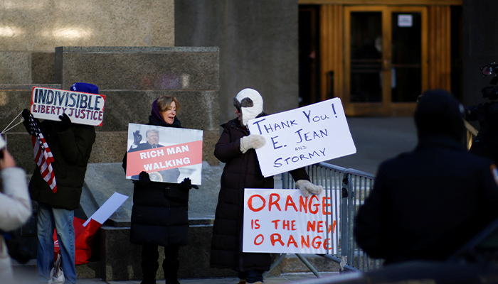 Supporters of US President-elect Donald Trump hold a banner and flags on the day of a sentencing hearing in the criminal case outside of New York Criminal Court in Manhattan in New York City, US, January 10, 2025. — Reuters