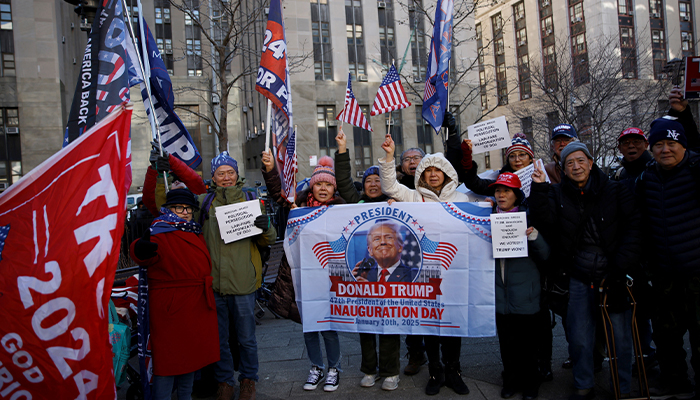 Supporters of US President-elect Donald Trump hold a banner and flags on the day of a sentencing hearing in the criminal case outside of New York Criminal Court in Manhattan in New York City, US, January 10, 2025. — Reuters