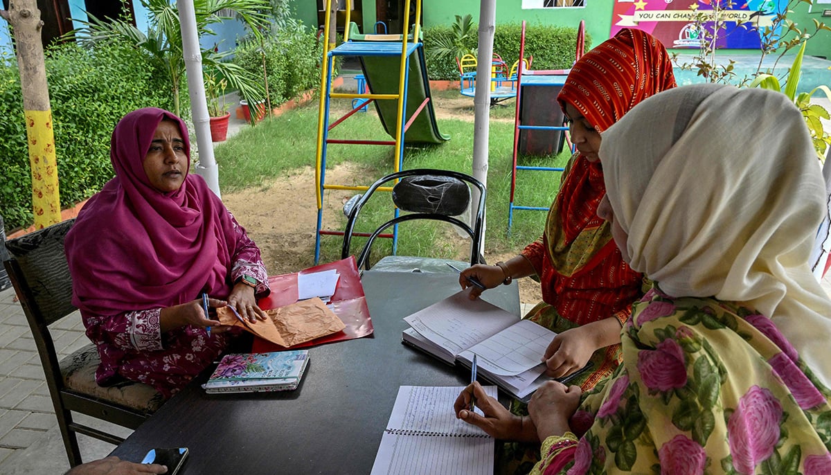 This photo taken on November 13, 2024 shows Humaira Bachal (L), a 36-year-old education advocate from the Roshan Pakistan Foundation School, speaking with teachers at a community school in Abdullah Goth village on the outskirts of Karachi. — AFP