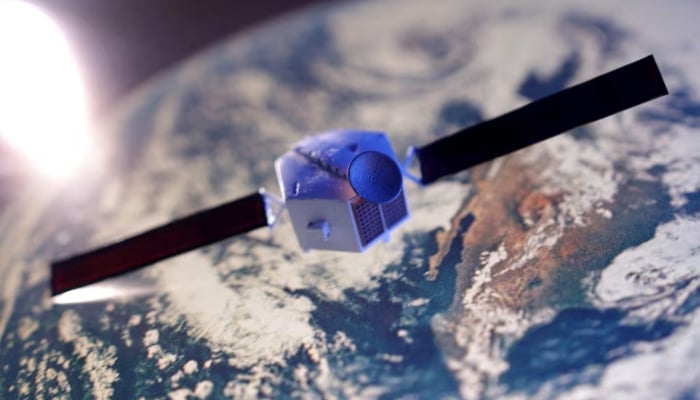 A satellite model is placed on a picture of Earth in this illustration taken on November 25, 2024. —Reuters