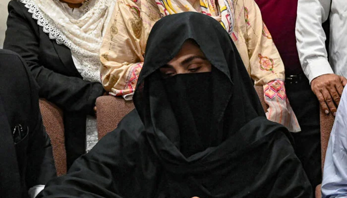 PTI founder-chairman Imran Khan and his wife Bushra Bibi are pictured while signing surety bonds for bail in various cases, at a registrar office in the Lahore High Court on July 17, 2023. — AFP