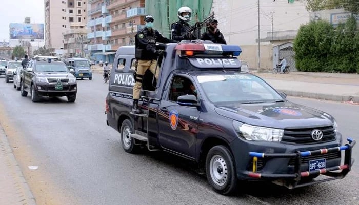 Police vehicles patrol on road in this undated image from Karachi. — APP/File