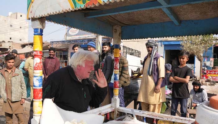 Saleem Bagga, seen by some as a lookalike of US President-elect Donald Trump, sings songs while selling kheer, a traditional South Asian rice pudding, along a road in Sahiwal, Pakistan January 13, 2025. — Reuters