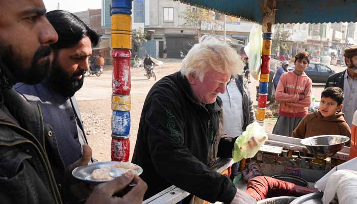 Saleem Bagga, seen by some as a lookalike of US President-elect Donald Trump, sells kheer, a traditional South Asian rice pudding, along a road in Sahiwal, Pakistan January 13, 2025. — Reuters