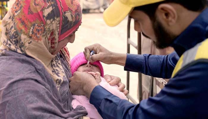 A health worker administers polio drops to child at Nori Gate in Sargodha on Feburary 27, 2024. — APP