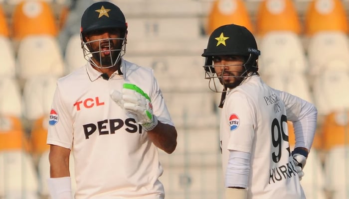 Pakistans captain Shan Masood (L) and Muhammad Hurraira during the second day of the first Test cricket match between Pakistan and West Indies at the Multan Cricket Stadium in Multan on January 18, 2025. — PCB