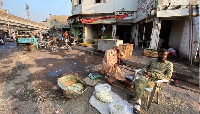 Wholesalers at Karachi’s Flower Market await buyers. — Reporter