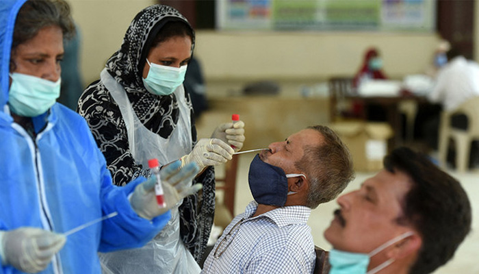 Health officials collect swab samples from people to test for the Covid-19 coronavirus in Karachi on September 14, 2020. — AFP