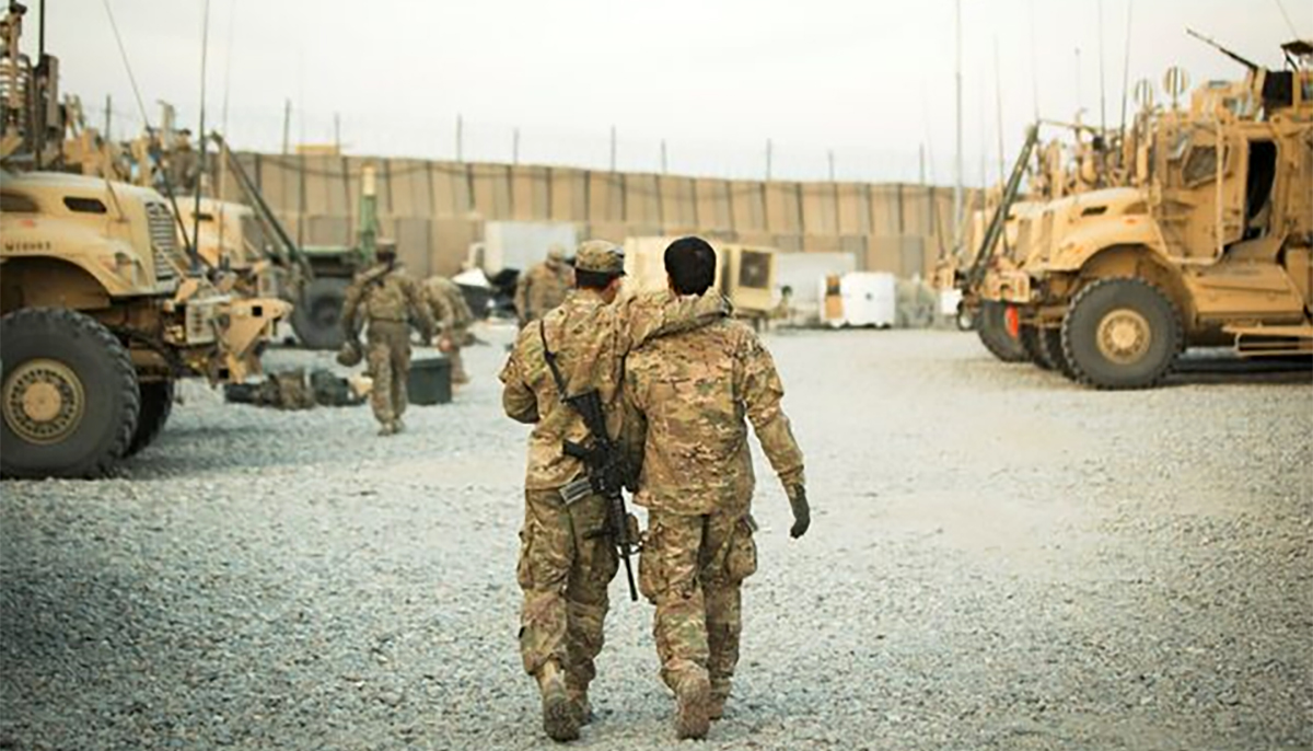 A US soldier from the 3rd Cavalry Regiment walks with the units Afghan interpreter before a mission near forward operating base Gamberi in the Laghman province of Afghanistan December 11, 2014. — Reuters