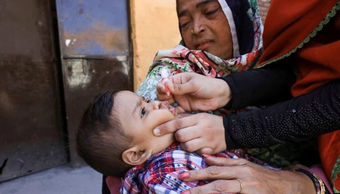 A child receives polio vaccine drops during an anti-polio campaign in Peshawar, Pakistan on February 17, 2020. — Reuters