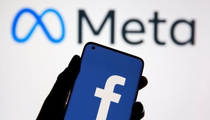 A smartphone with Facebooks logo is seen in front of Meta logo in this illustration taken on October 28, 2021. — Reuters